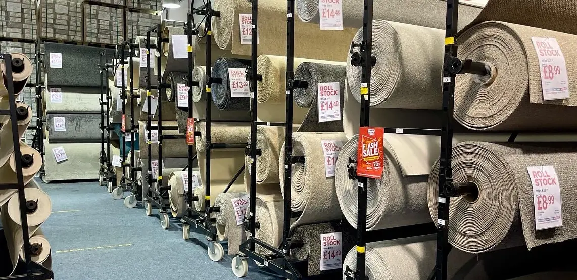 Various rolls of colorful carpets displayed in the showroom of Flooring Factory Outlet located in Croydon.