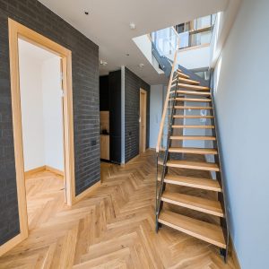 Indoor staircase featuring waterproof engineered wood flooring, highlighting emerging trends in durability and style, seamlessly blending functionality with modern home design.